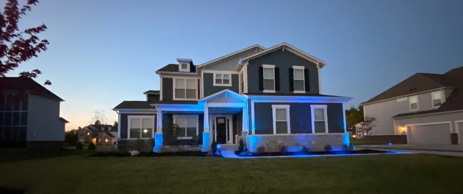 Home in Carmel, IN, with blue landscape lights.