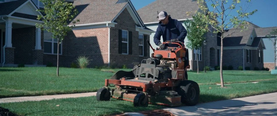 Mowing lawn in suburban area.