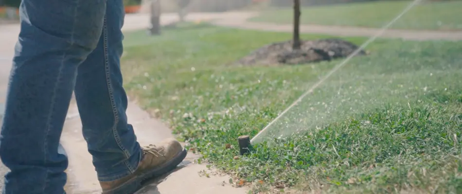 Running sprinkler system on a lawn in Fishers, IN.