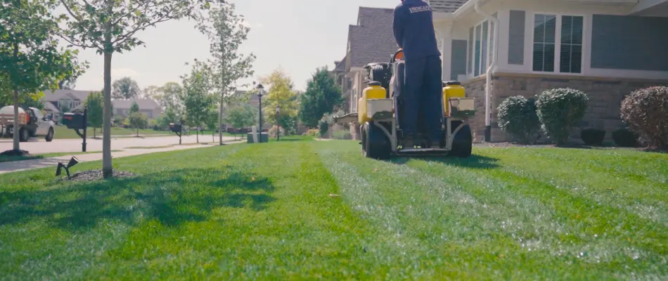 Worker fertilizing lawn in Cicero, IN.