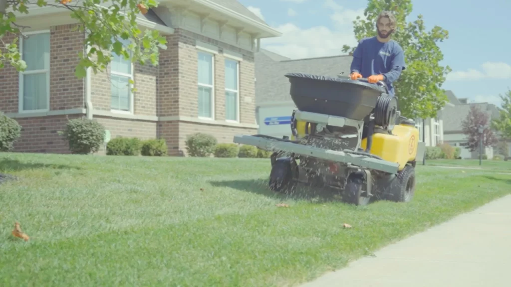 How Many Spring Fertilizer Treatments Does Your Lawn in Indiana Need? banner-worker-fertilizing-lawn
